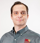 A man wearing a grey shirt.