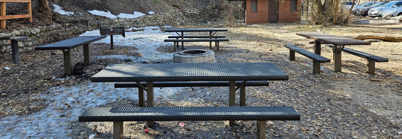 A group of picnic tables in a park.
