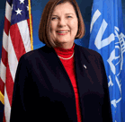 A man in front of a flag.