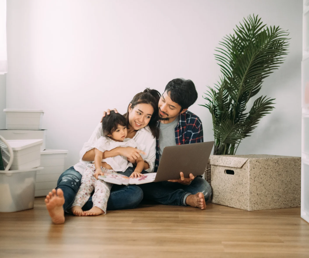 A family sitting on the floor.