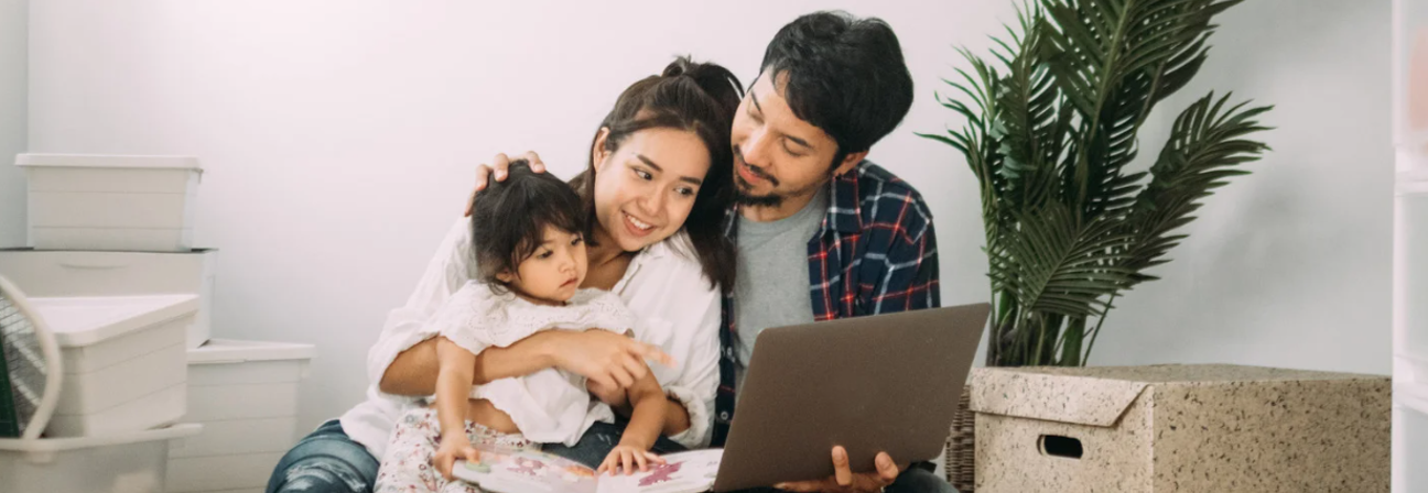 A family sitting on the floor.