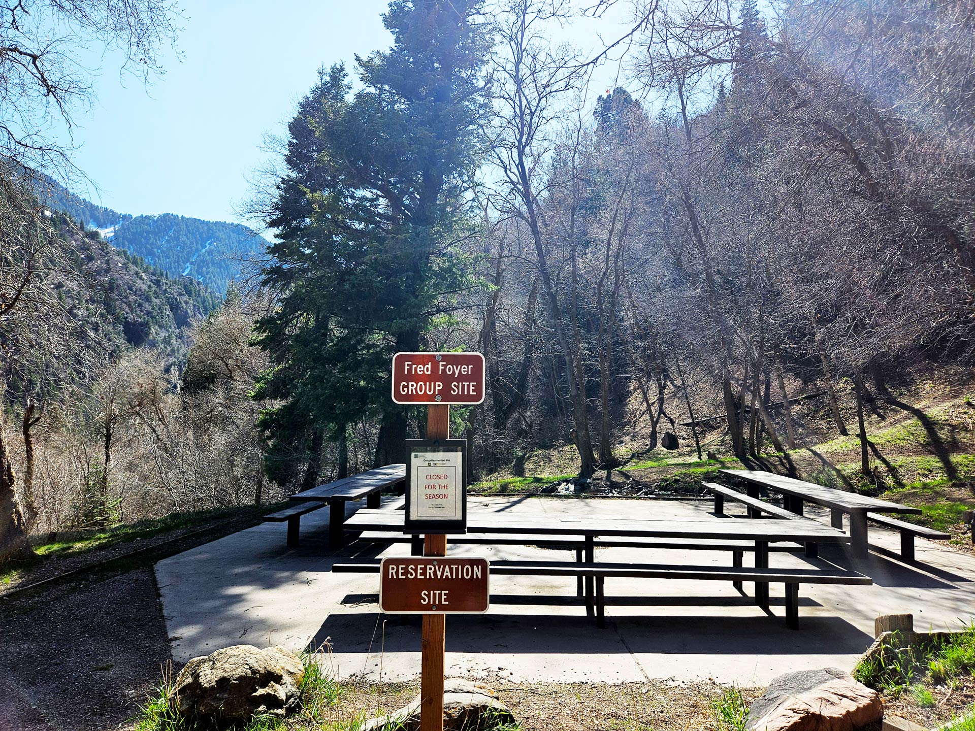 A group picnic site with signs posted about various rules to follow.