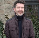 A man wearing a brown jacket.