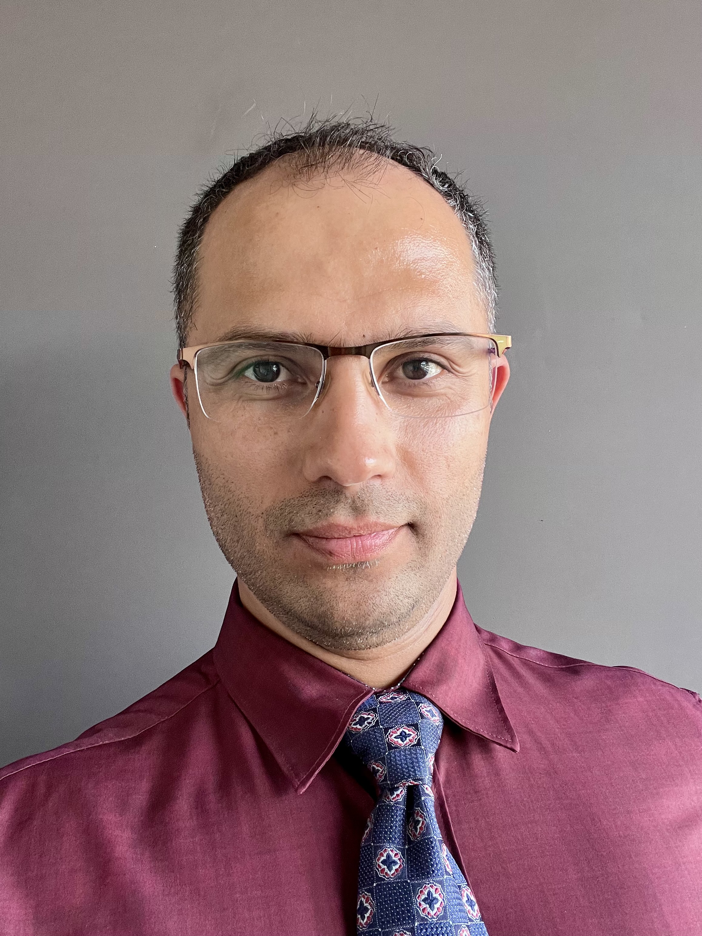 A man wearing glasses and a tie.