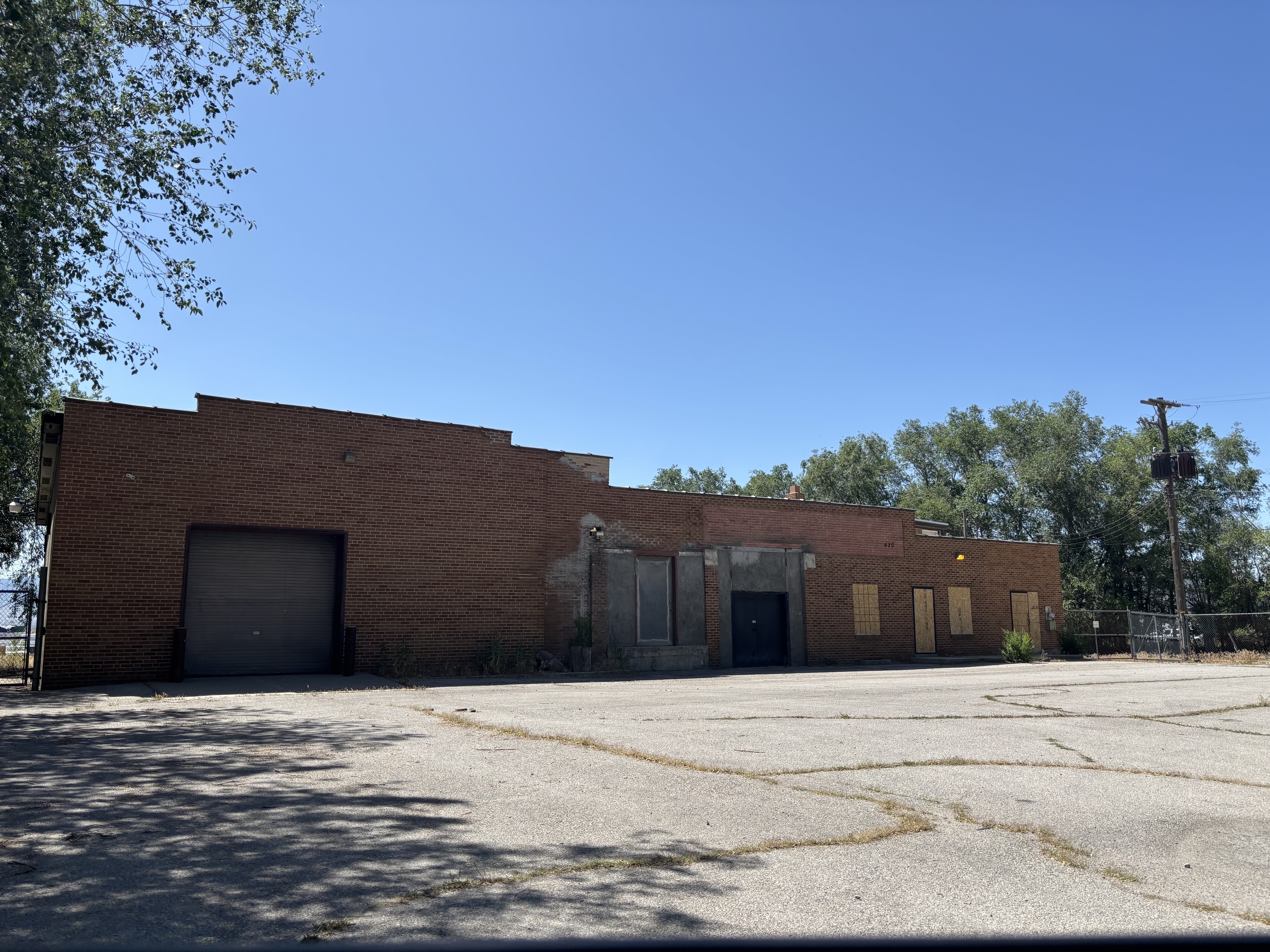 A brick building with a fence around it.