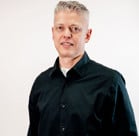 A man wearing a black jacket.