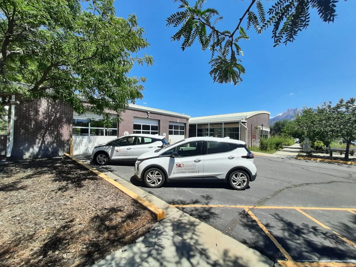 A couple of cars parked in front of a building.