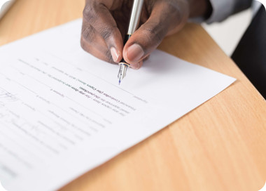 A person writing on a piece of paper.