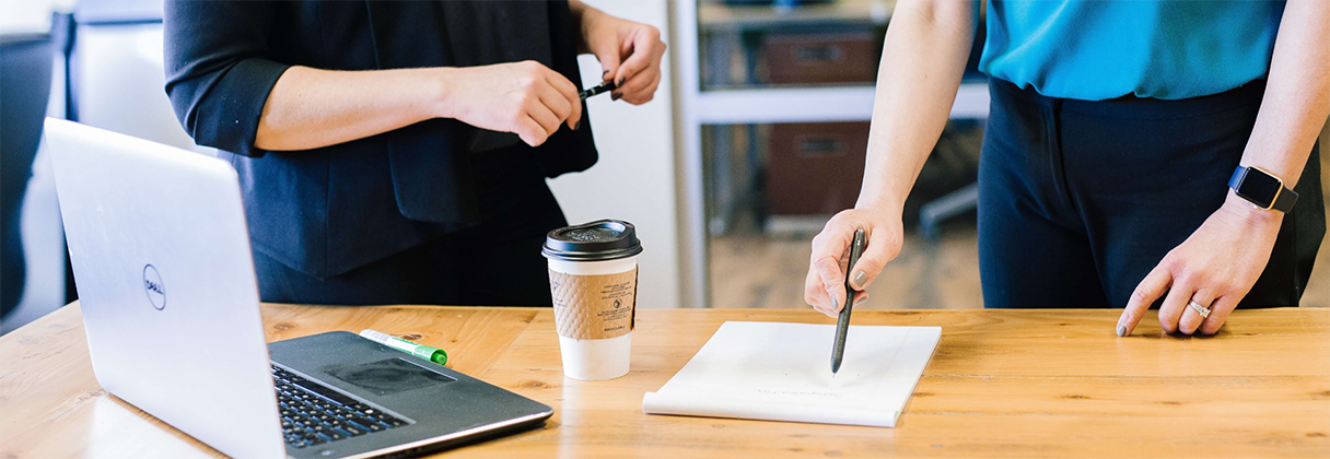 A few people working at a table.