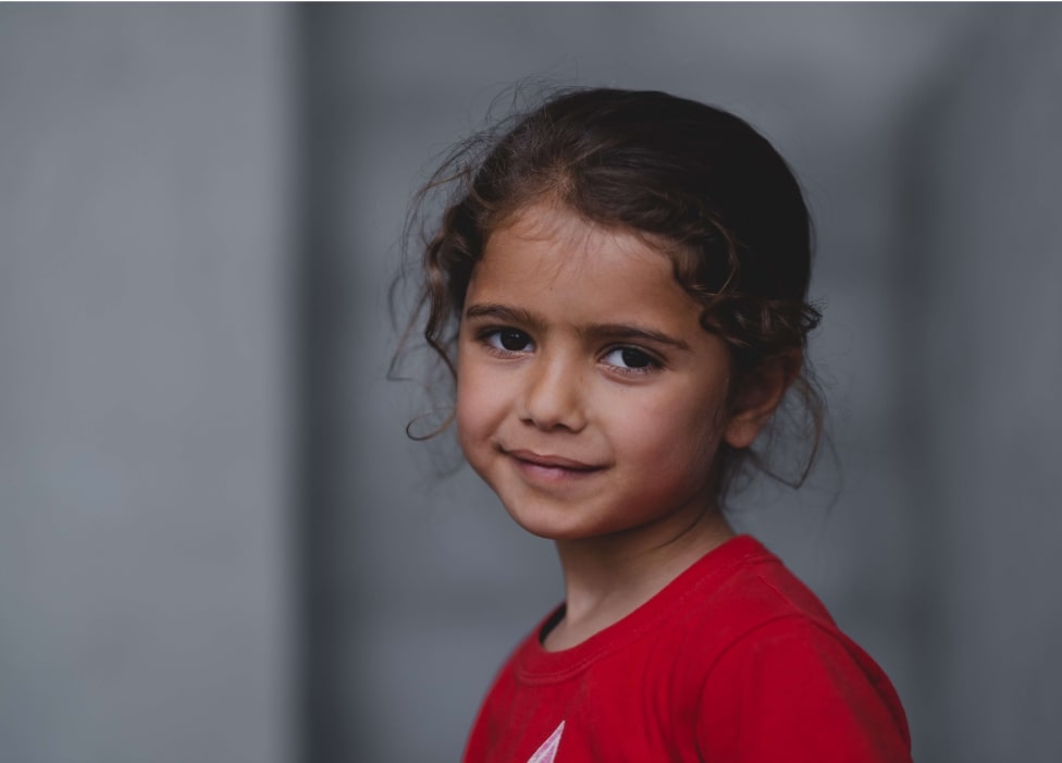 A young girl smiling.