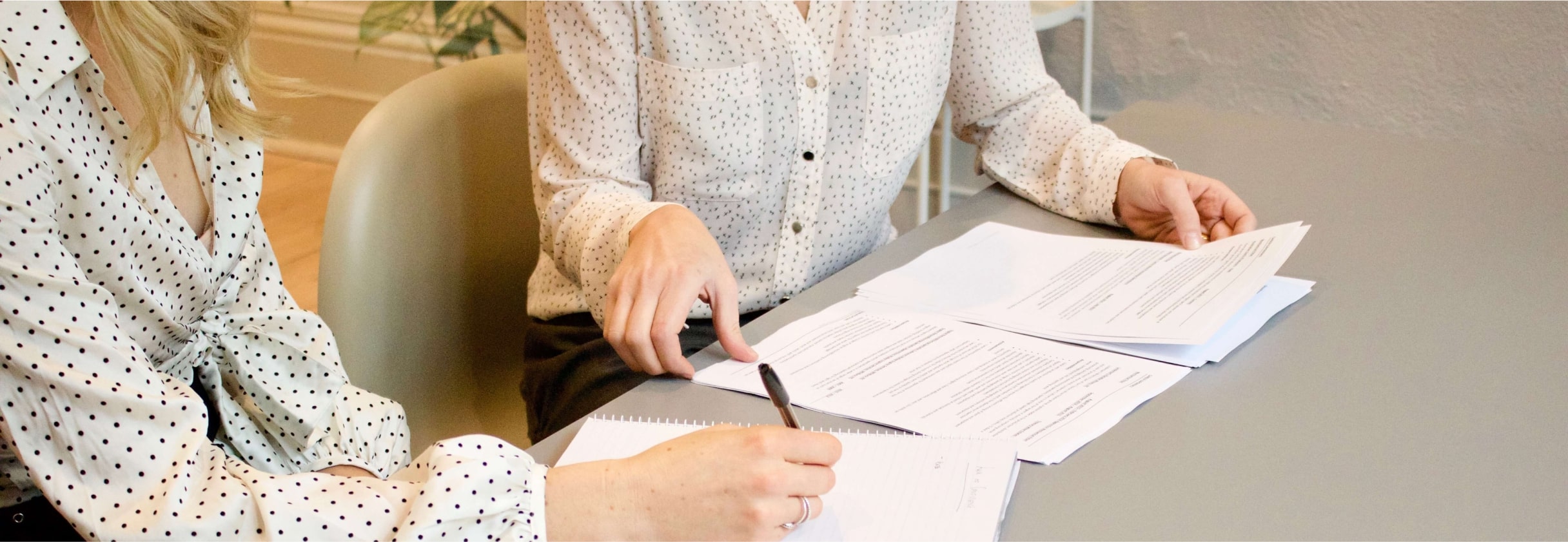 A person signing a document.