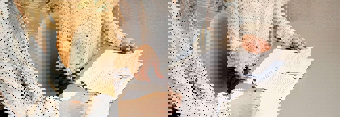 A person signing a document.