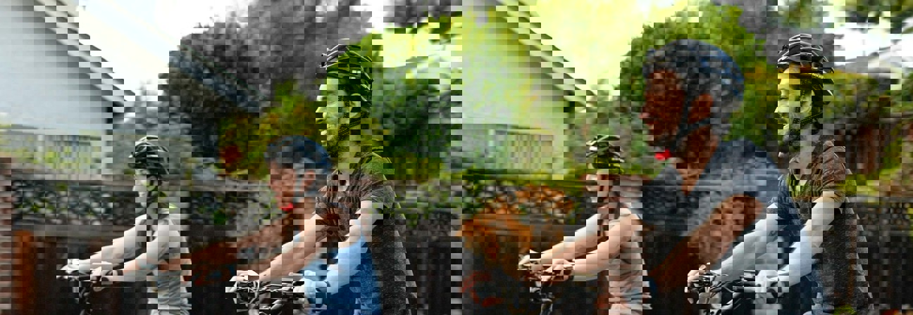 A man and a woman riding bikes.