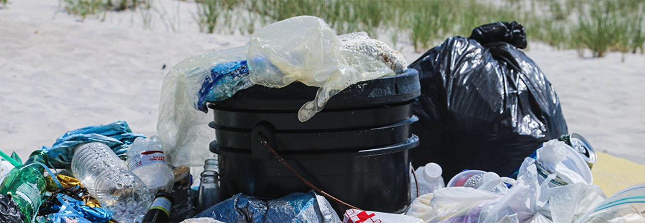 A garbage can with a pile of garbage in it.