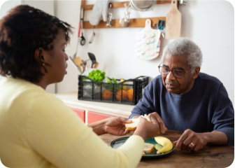 A man and a woman eating at a table.