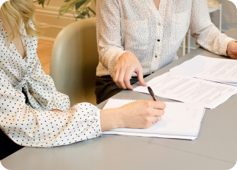 A woman writing on a piece of paper.