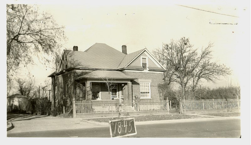 A house with a sign in front of it.