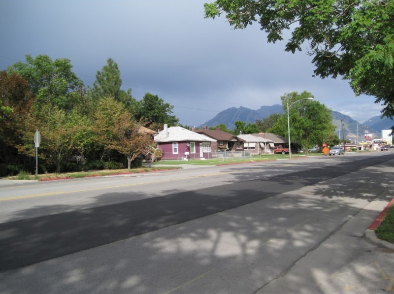 A street with houses and trees.