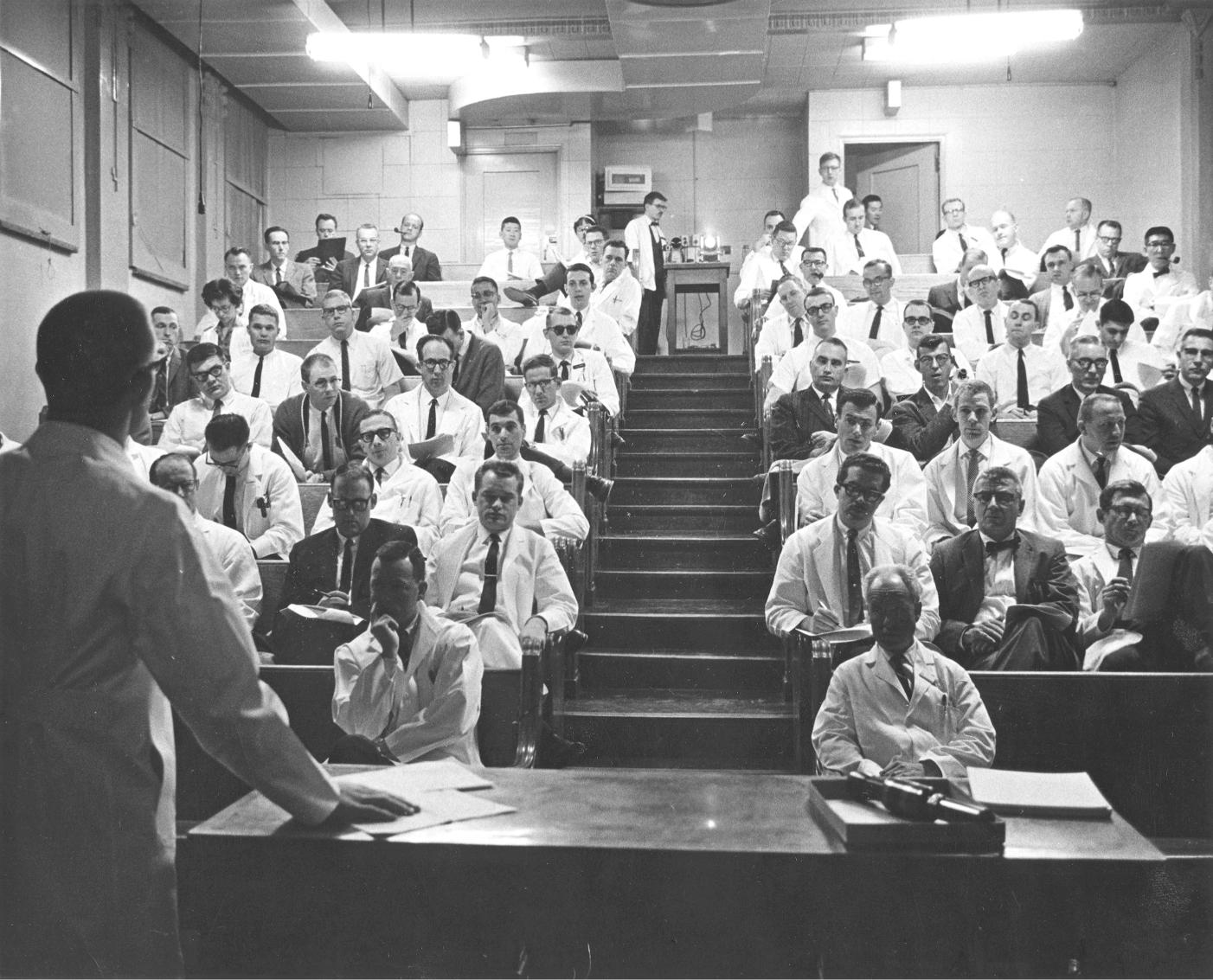 A man addressing a group of people.