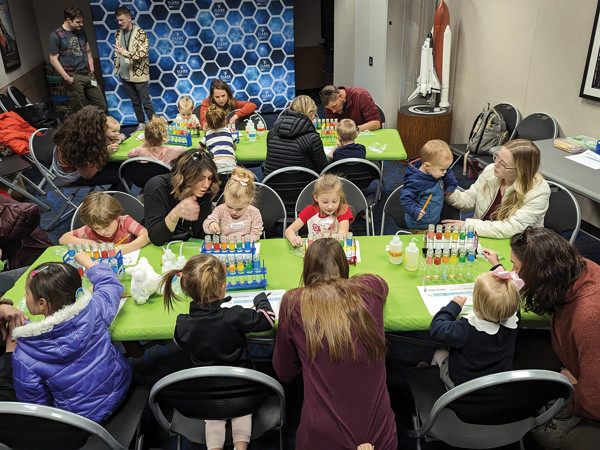 A group of children sitting around a table.