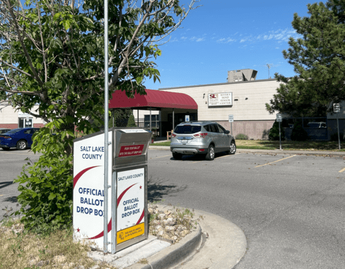 A gas station with a car parked in the parking lot.
