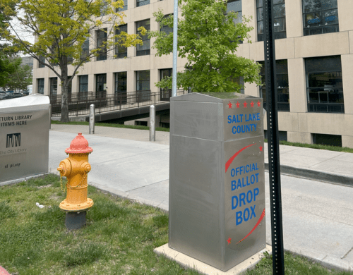 A fire hydrant next to a mailbox.