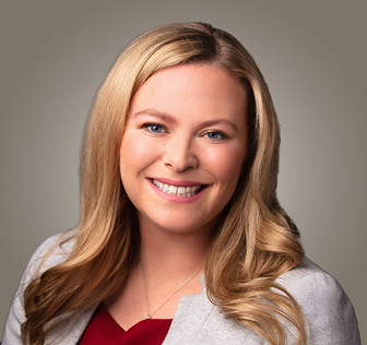 A woman with long hair smiling.