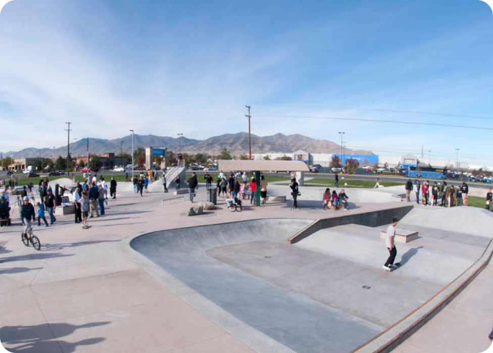 A skateboarder rides down a ramp.