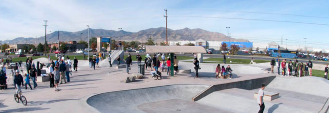 A skateboarder rides down a ramp.
