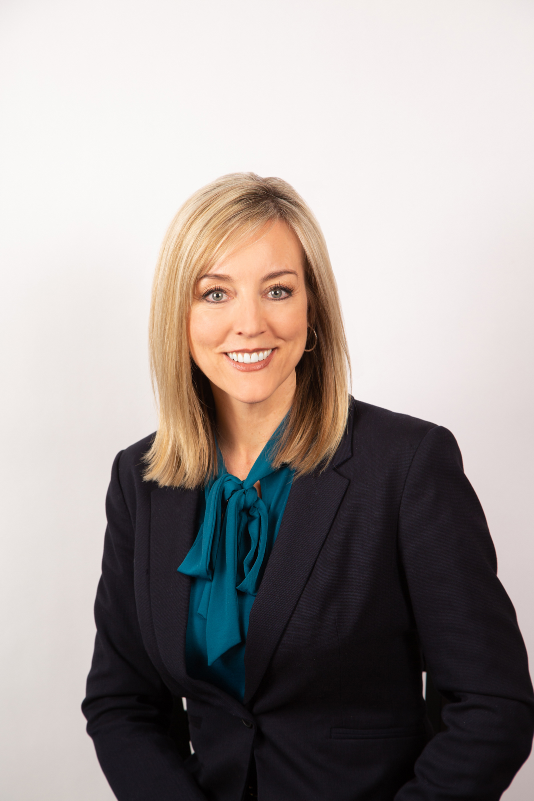 Aimee Winder Newton in a suit smiling.