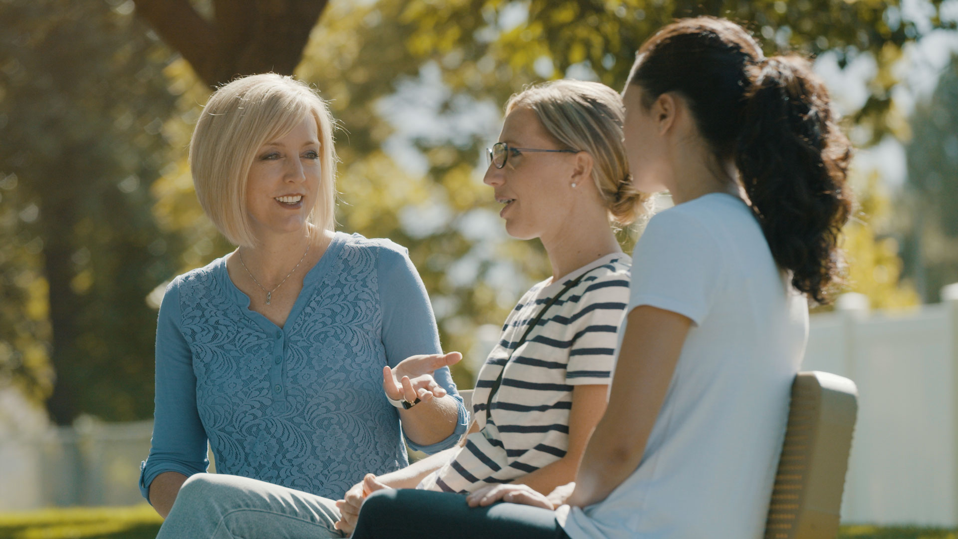 A group of women sitting outside.