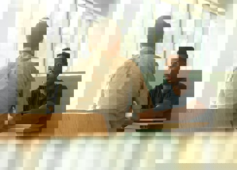 A man sitting next to another man.