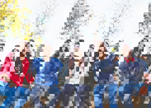 A group of people sitting together smiling.