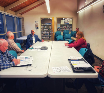 A group of people sitting around a table.