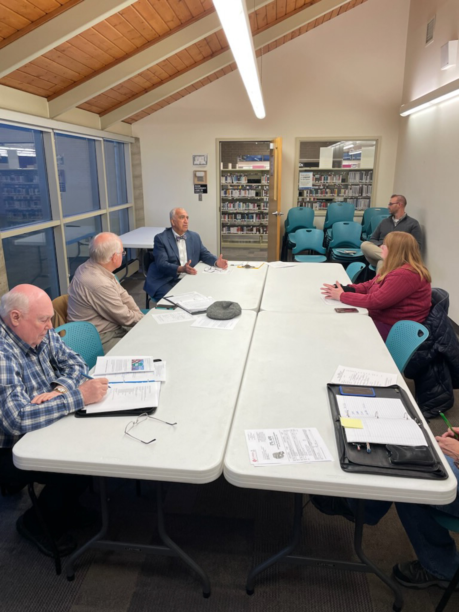 A group of people sitting around a table.