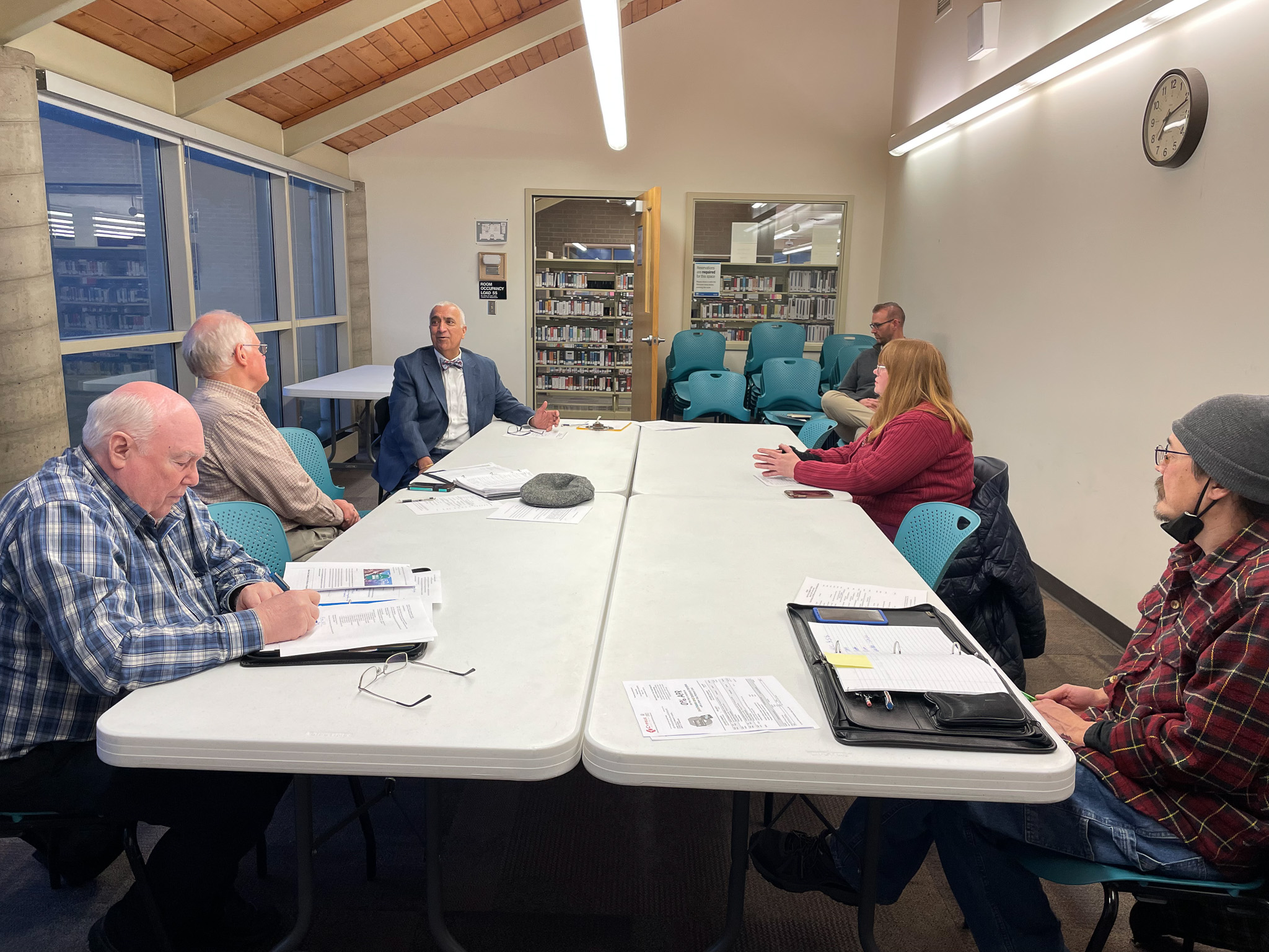 A group of people sitting around a table.