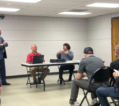 A group of people sitting around a table.