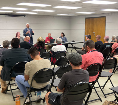 A person addressing a group of people.