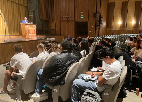 A group of people sitting in chairs.