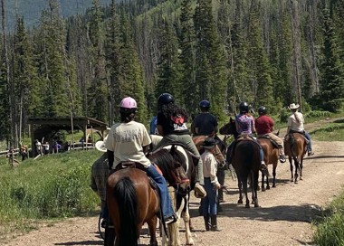 A group of people riding horses.
