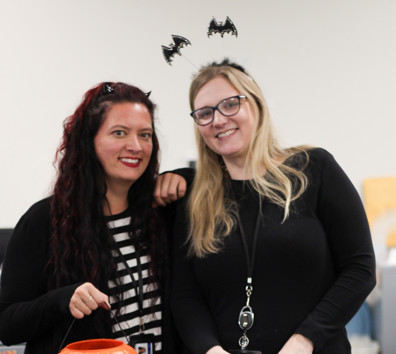 Two women holding a box.