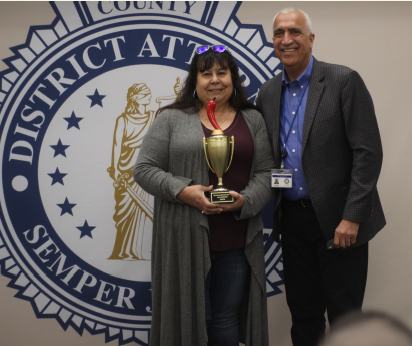 A man and a woman holding a trophy.