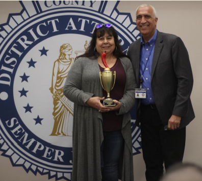 A man and a woman holding a trophy.