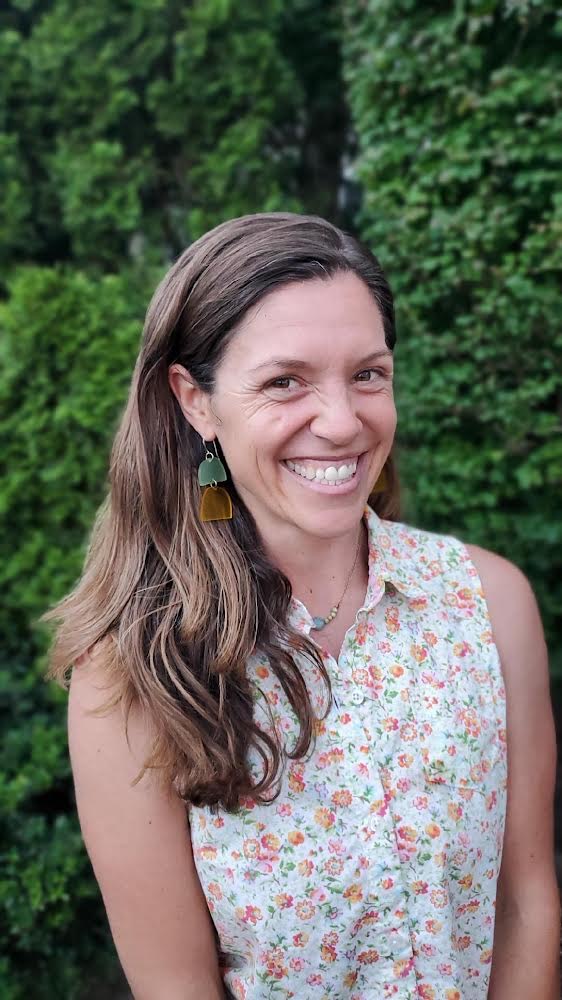 A woman smiling for the camera.