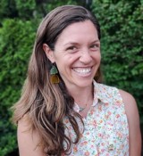 A woman smiling for the camera.