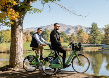 Two men on a bicycle.