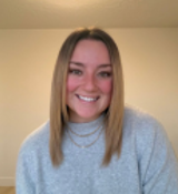 A woman smiling for the camera.