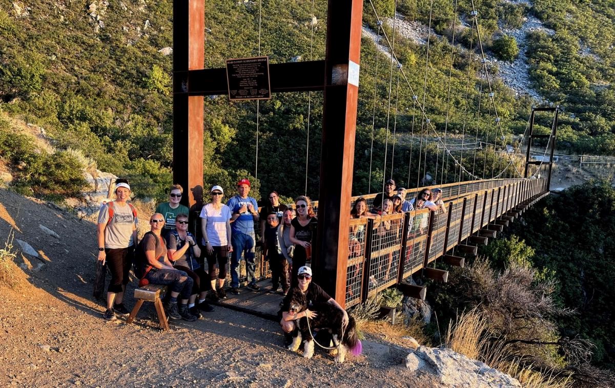 A group of people on a suspension bridge.