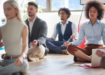 A group of people sitting on the floor.