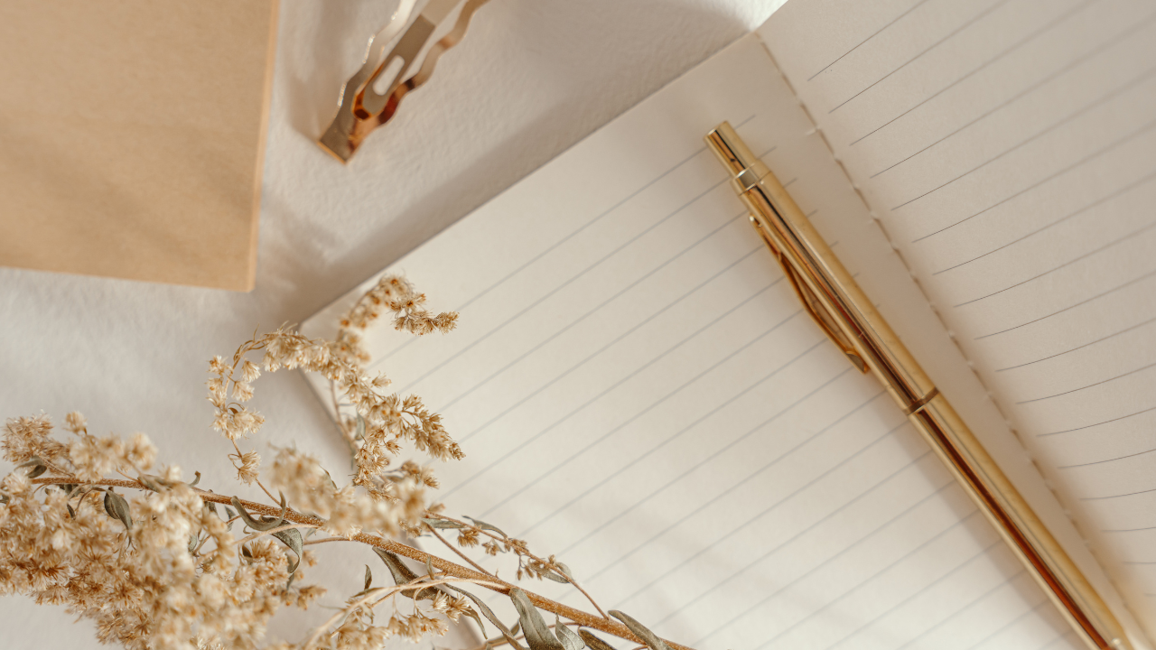 A gold cross on a white surface.